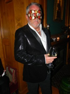 A masked guest from NYC in a tux interpreted in a black sequin jacket at the Caribou charity event