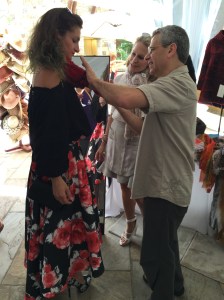 Furrier Mark Richards styling a fur scarf on Alex Wein